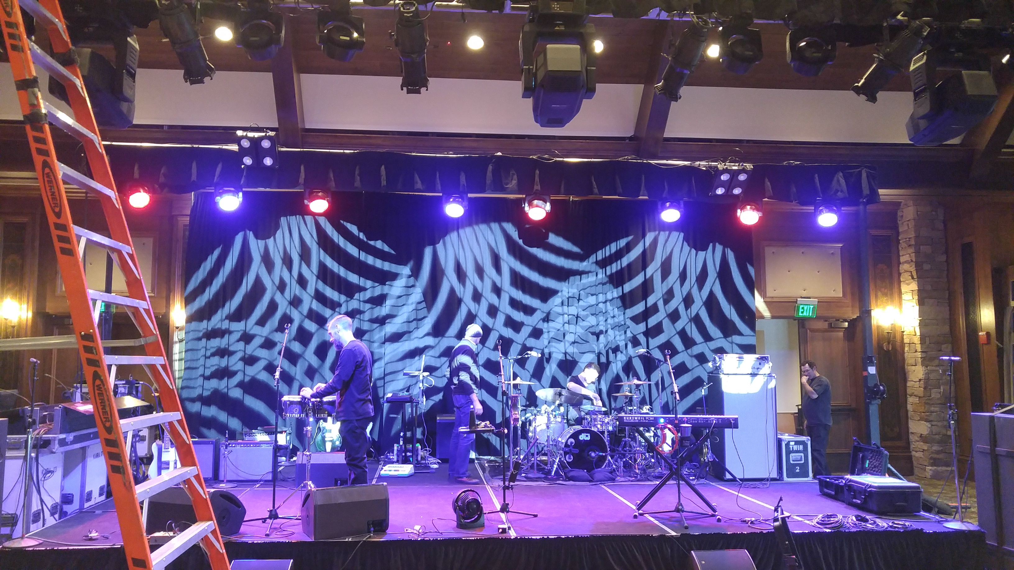 Band on stage with a projection-mapped backdrop