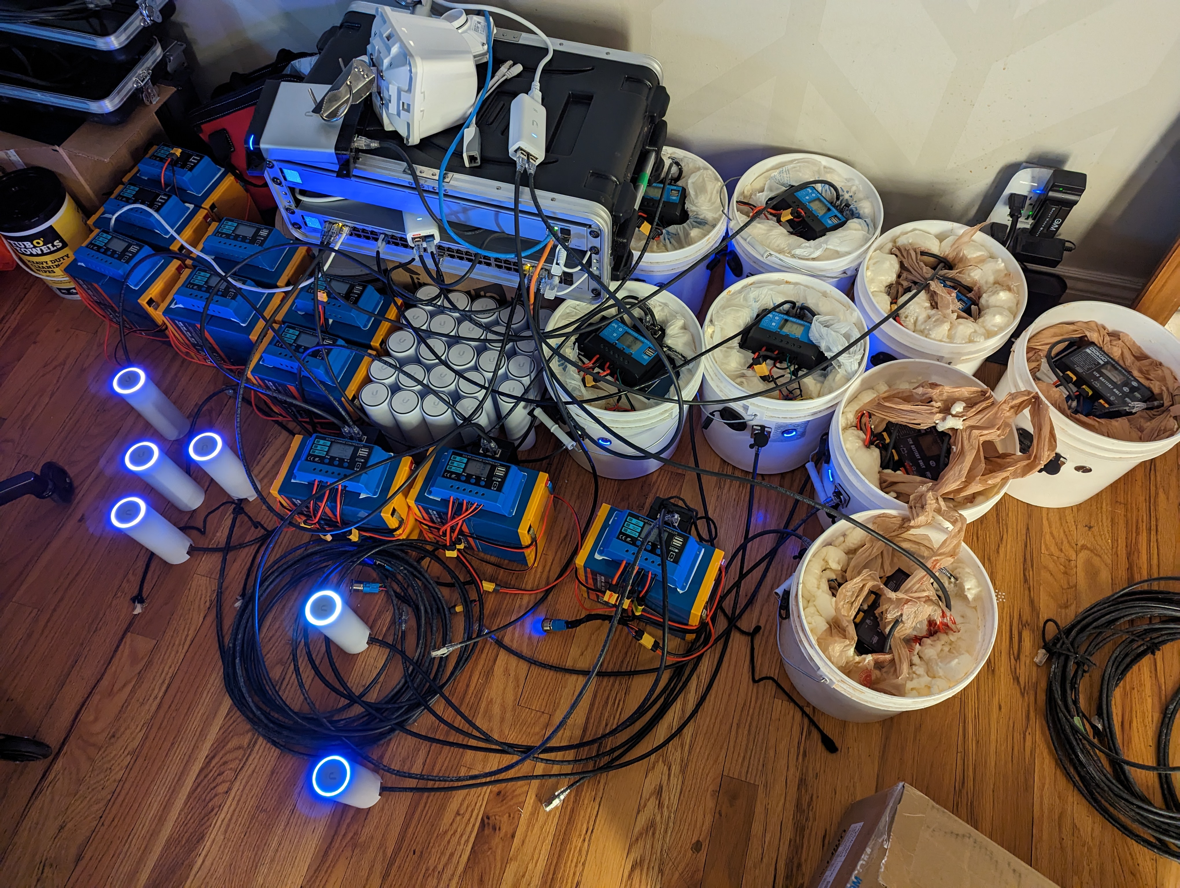 Hand-built Bucky nodes — batteries, access points, and cabling glowing blue