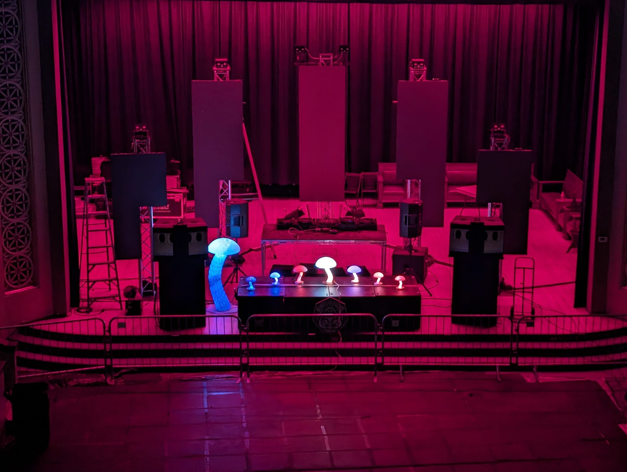 Theater stage with line arrays and uplit set pieces