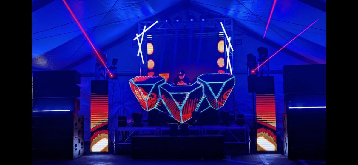 Blue-lit video DJ booth with LED wall