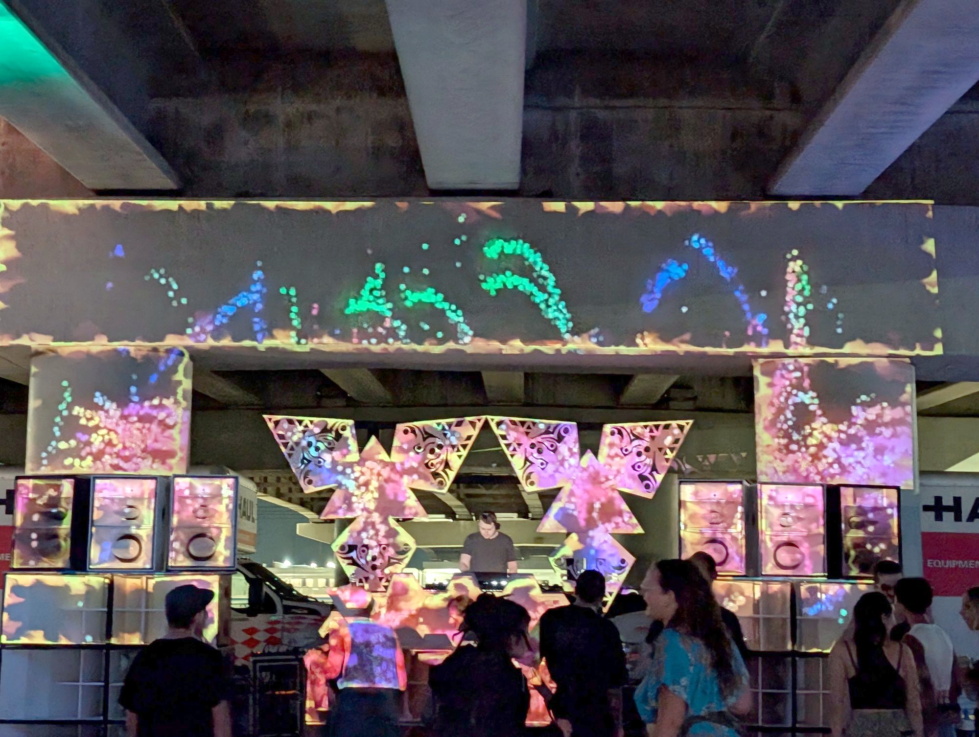 Projection-mapped festival stage with the crowd in